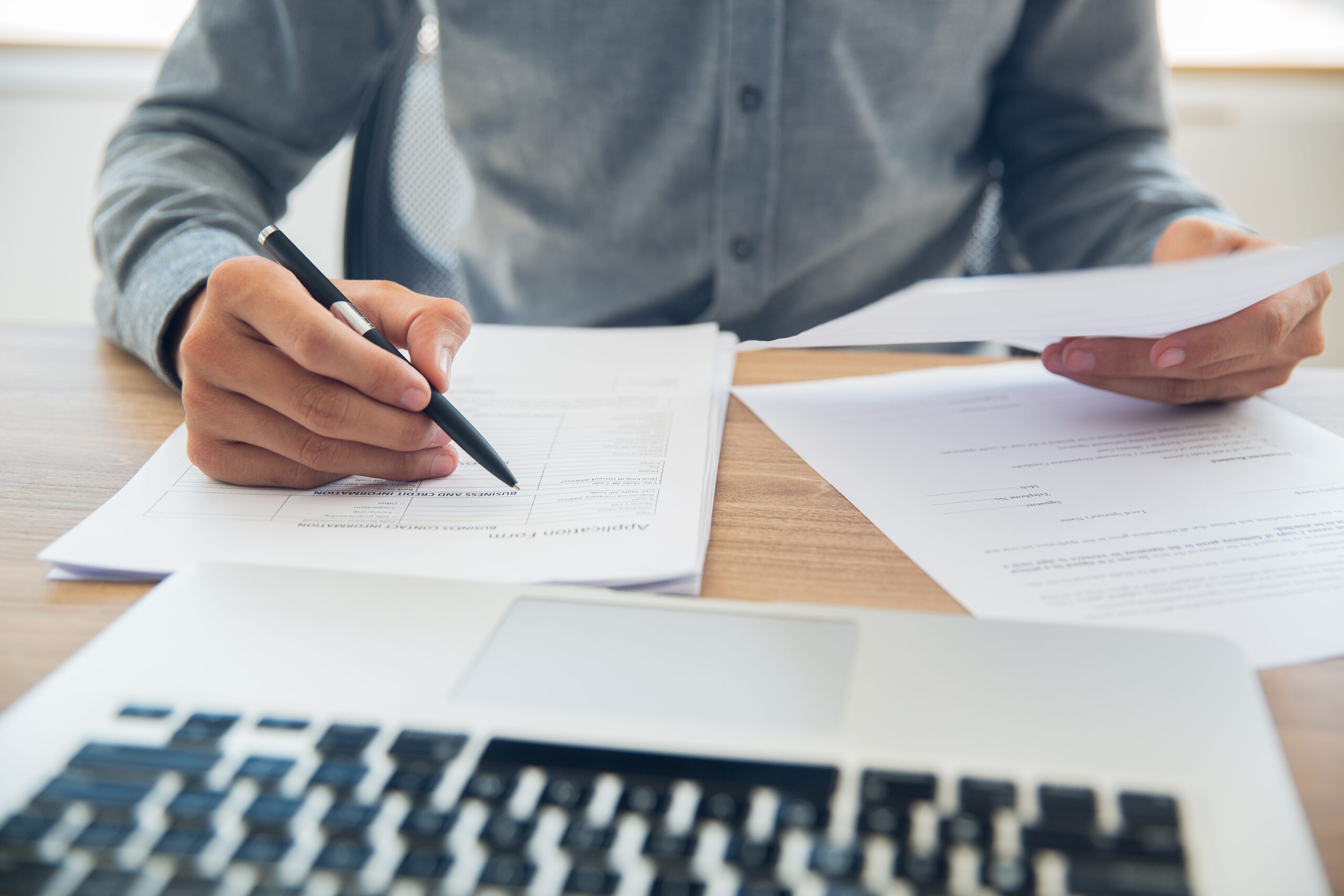 businessman checking documents table scaled حقوق تجارت